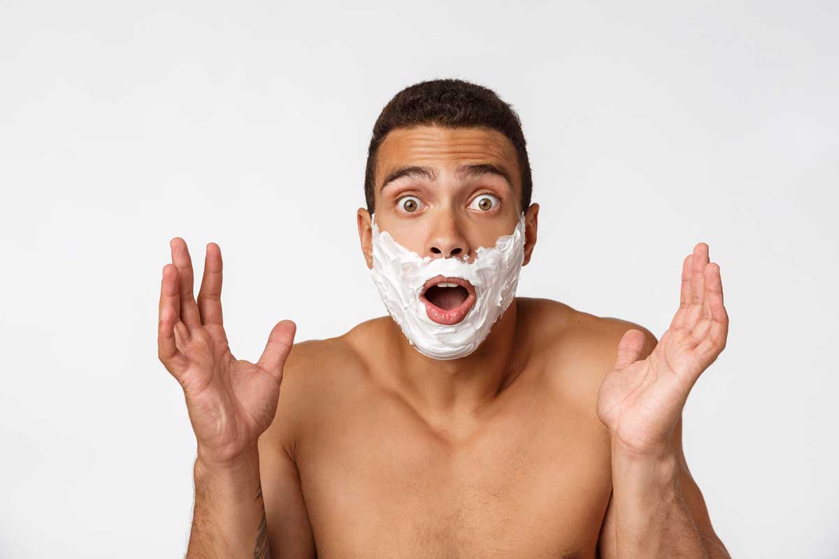 Surprised man with shaving cream,