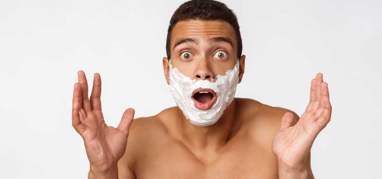 Surprised man with shaving cream,